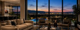 Great room opening to a pool deck with Las Vegas Strip views at dusk