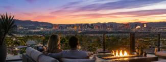 Couple by a fire pit on a view deck overlooking the Las Vegas Strip